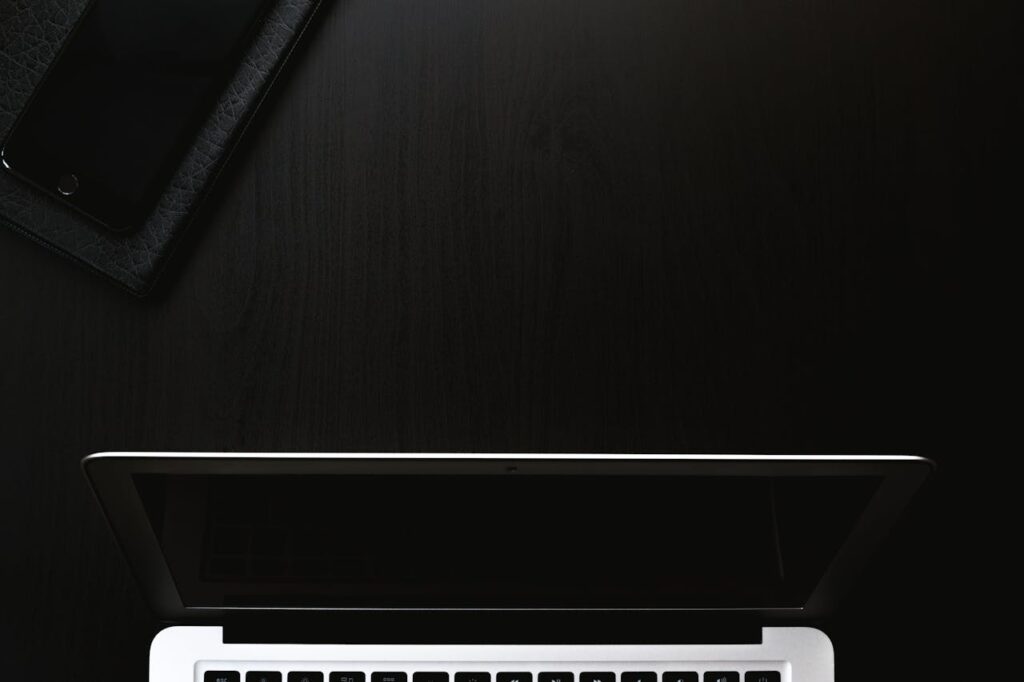 black background and white laptop placed in atable