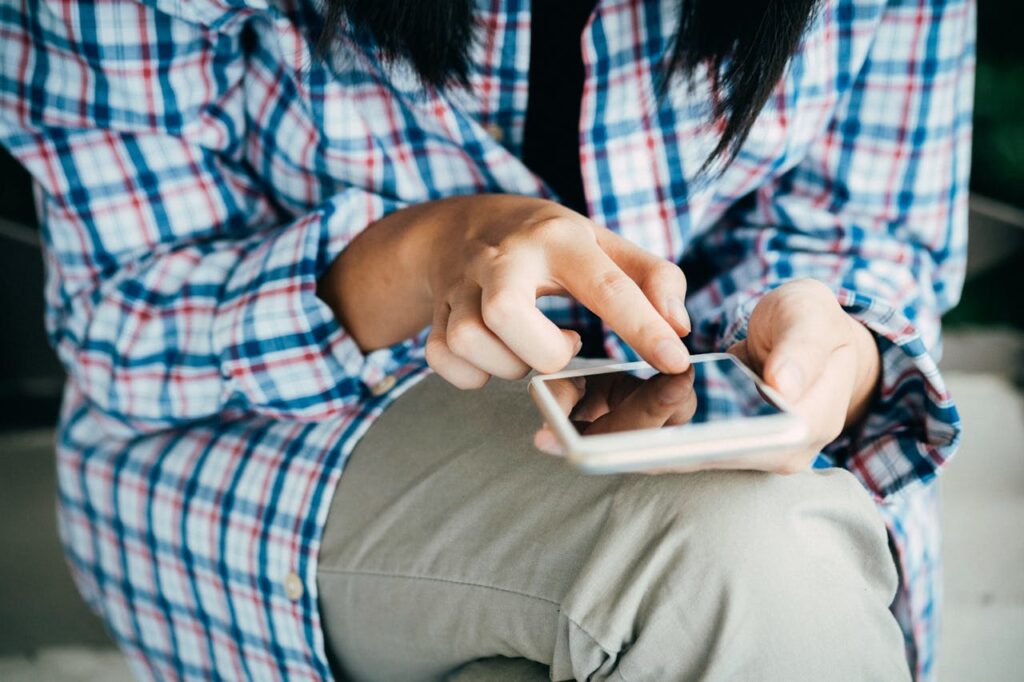 a girl doing something in the phone