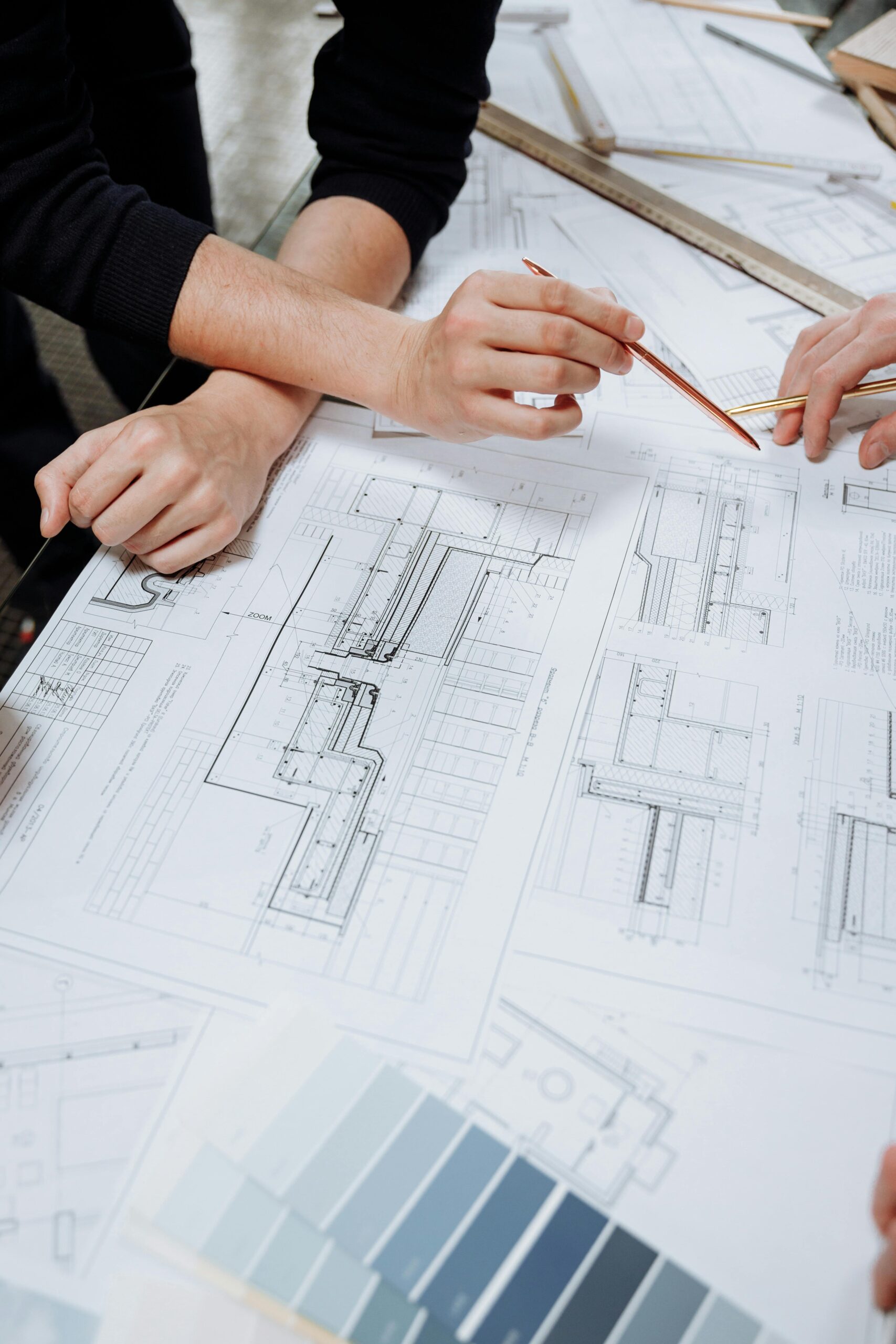 A PERSON DRAWING A PLAN IN WHITE PAPERS WITH A PENCIL, TECHNICAL SEO